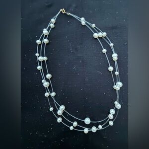 Multi strand, cultured, pearl necklace on transparent chain.
